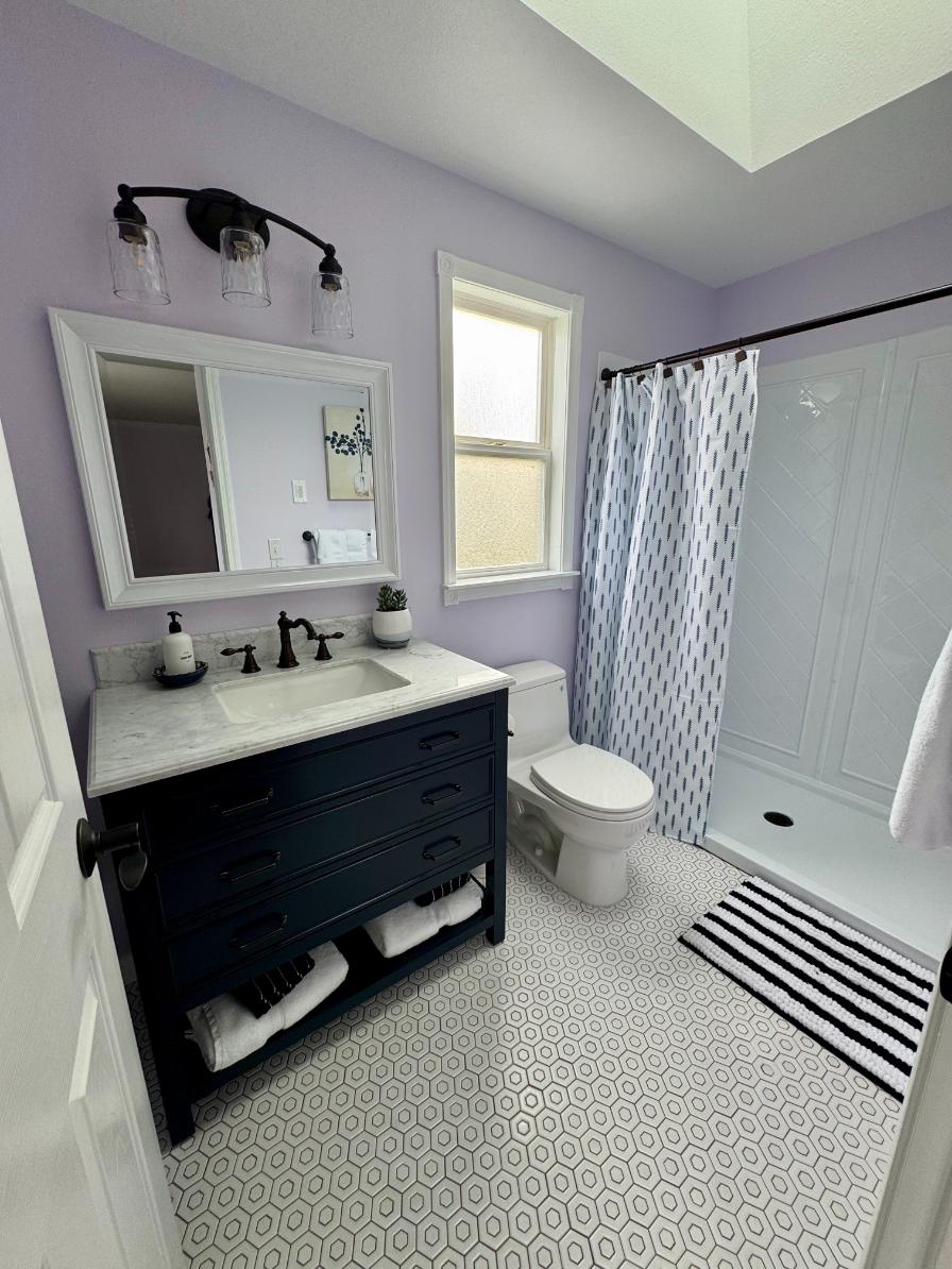 White vanity with purple accent wall Enumclaw WA